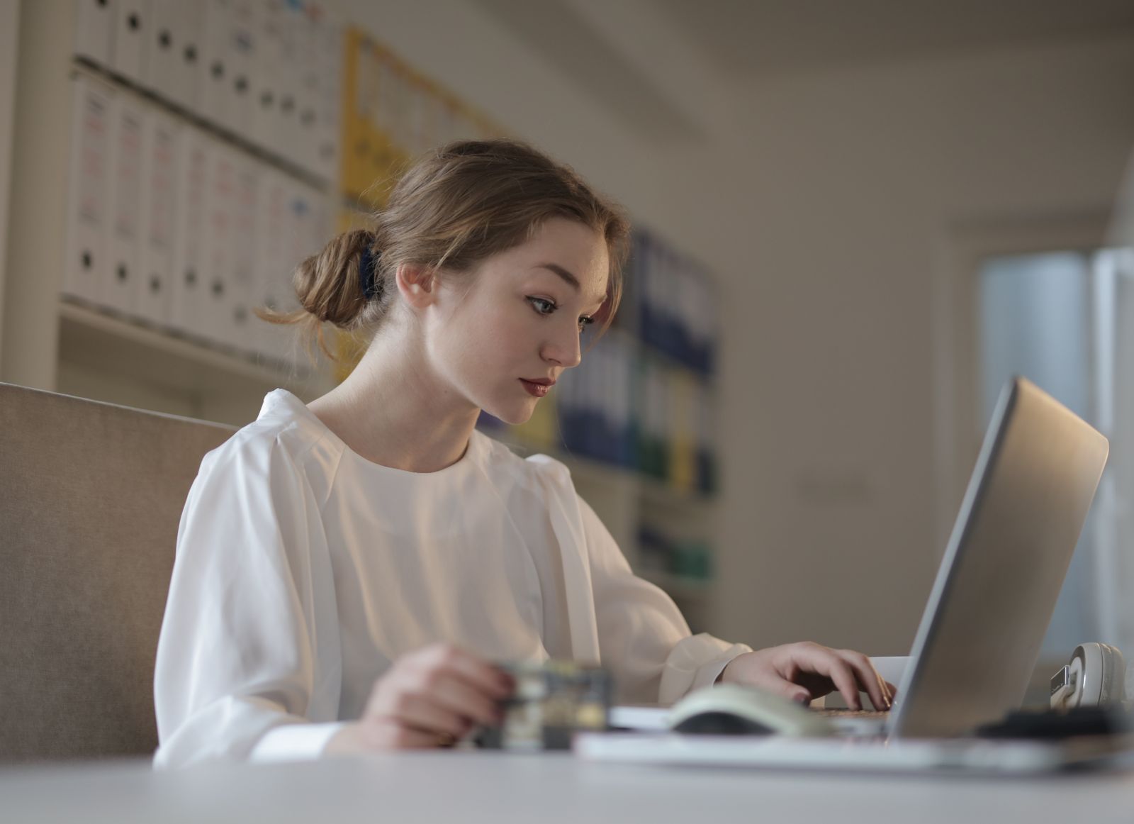 Person carefully reviewing an email on a laptop.